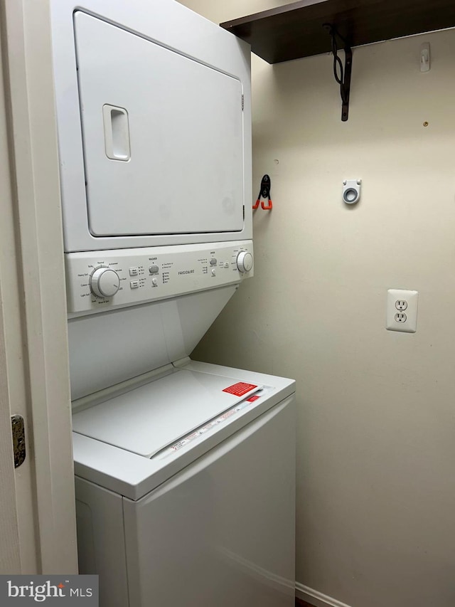 laundry room with stacked washer and dryer