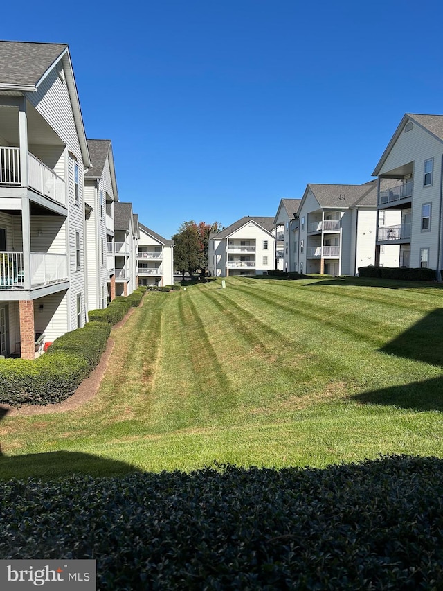 view of yard with a balcony