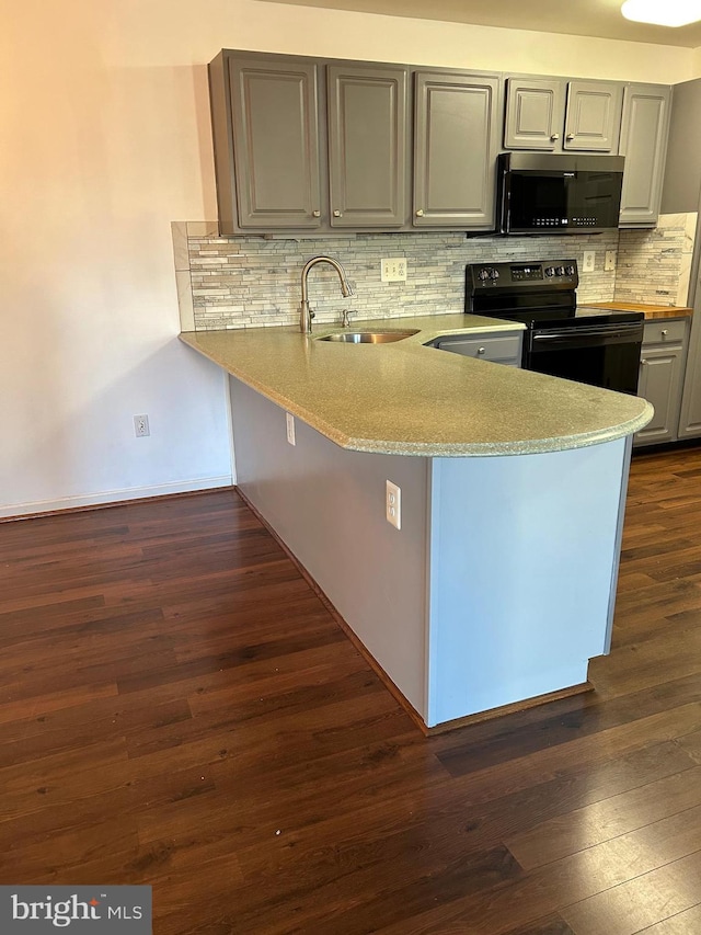 kitchen with sink, black range with electric stovetop, dark hardwood / wood-style flooring, kitchen peninsula, and decorative backsplash