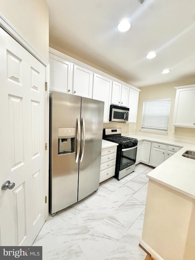 kitchen featuring appliances with stainless steel finishes and white cabinets