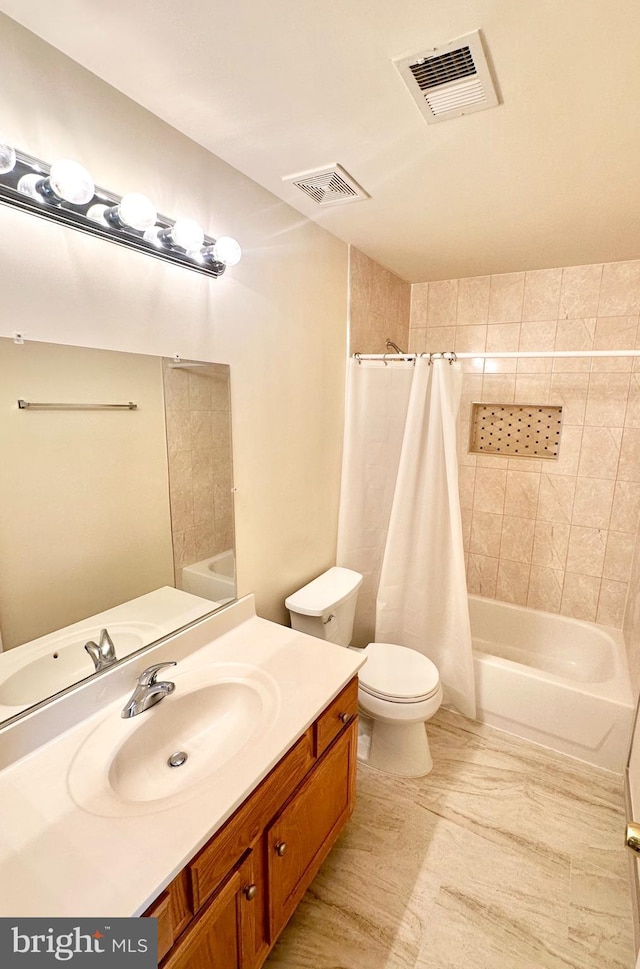 full bathroom featuring vanity, shower / bath combination with curtain, and toilet