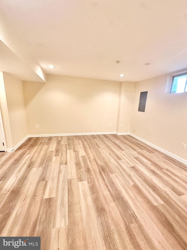 basement with light hardwood / wood-style flooring