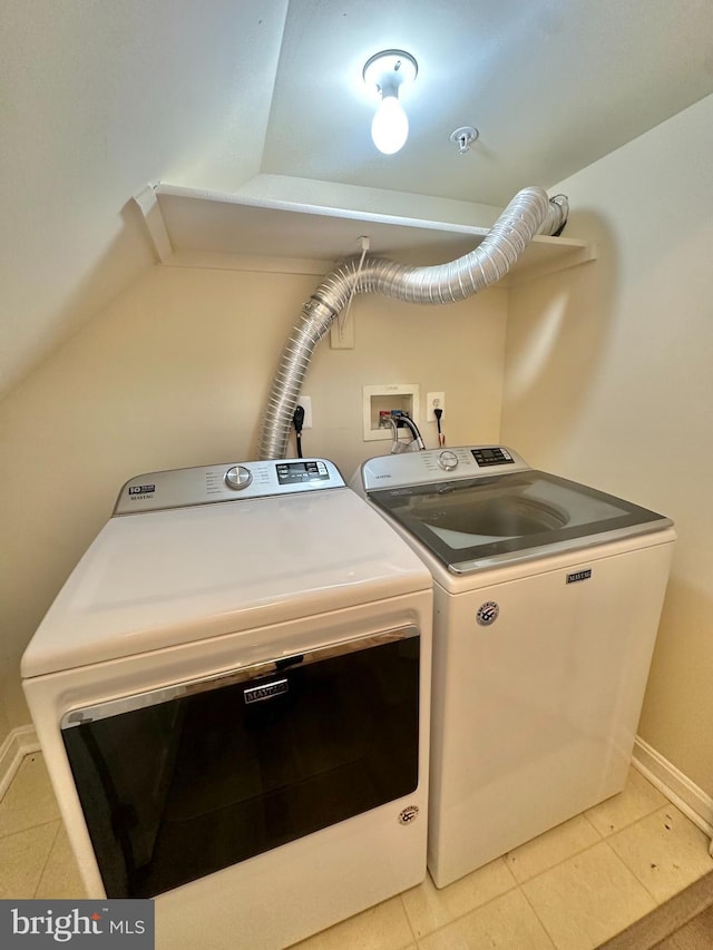 laundry area featuring light tile patterned flooring and separate washer and dryer