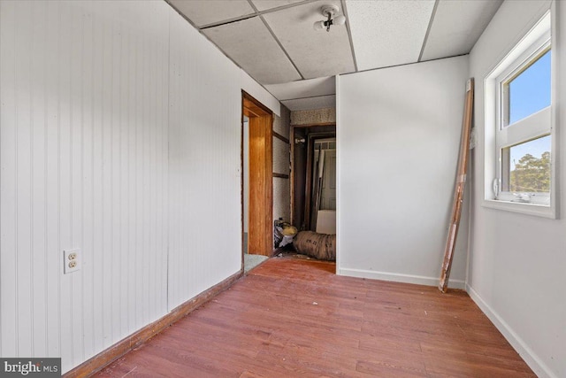 interior space featuring hardwood / wood-style flooring and a paneled ceiling