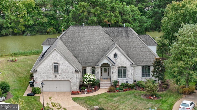 french provincial home featuring a garage and a front yard