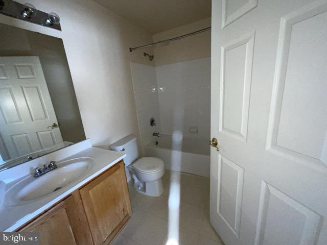 full bathroom with vanity, toilet, tile patterned floors, and shower / bathing tub combination