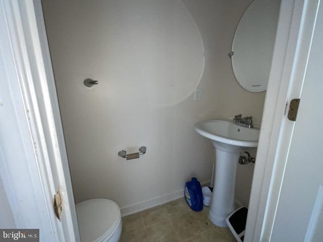 bathroom featuring toilet and tile patterned floors