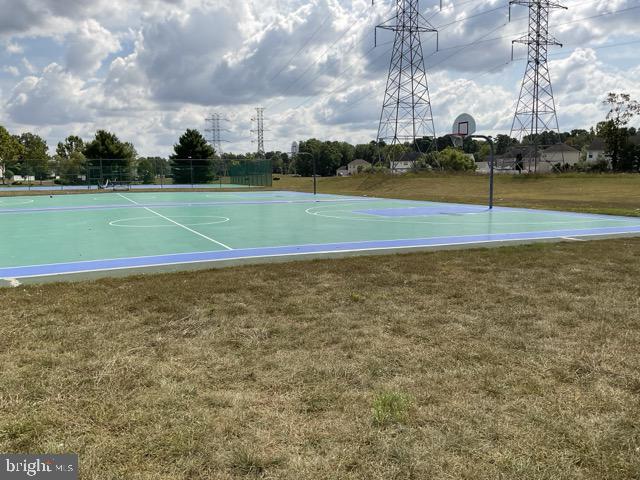 view of basketball court with a lawn