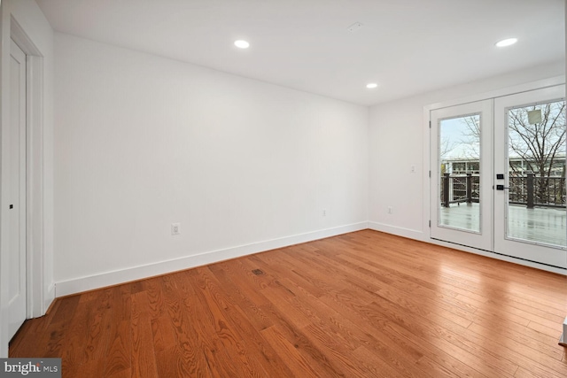 unfurnished room with light hardwood / wood-style flooring and french doors