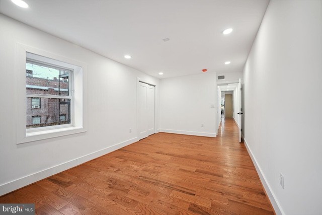 unfurnished room with light wood-type flooring