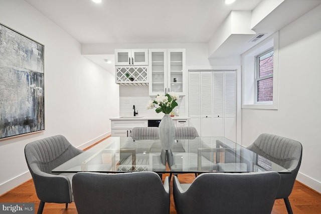 dining space with hardwood / wood-style flooring and sink