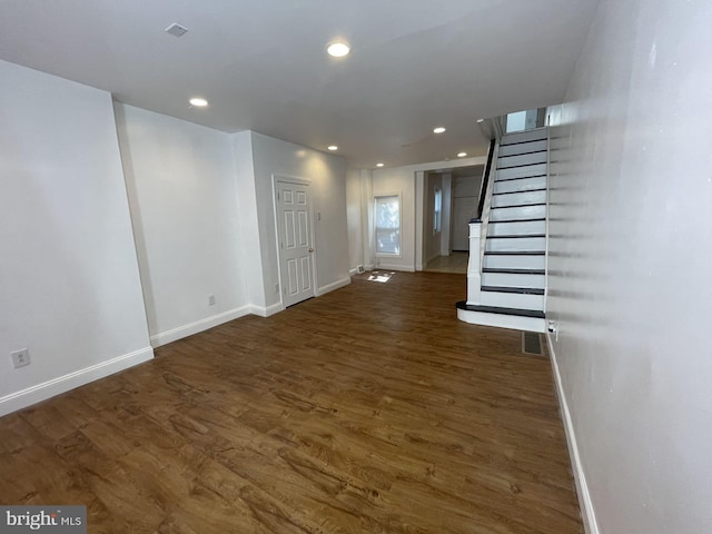 unfurnished living room with dark hardwood / wood-style floors