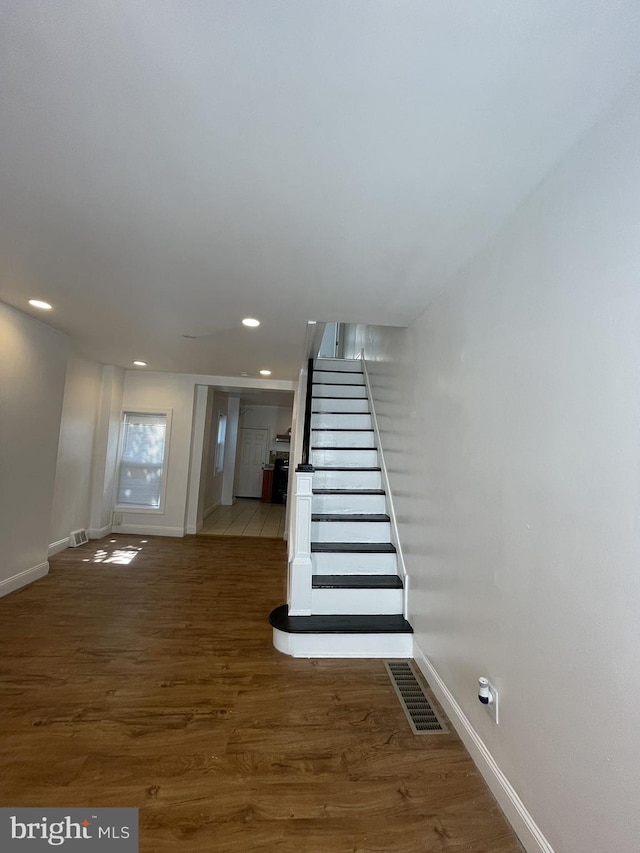 stairway with hardwood / wood-style flooring