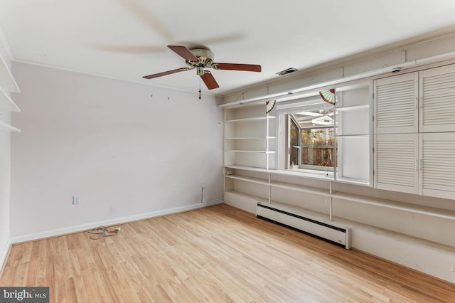 empty room with ceiling fan, a baseboard radiator, and light hardwood / wood-style floors