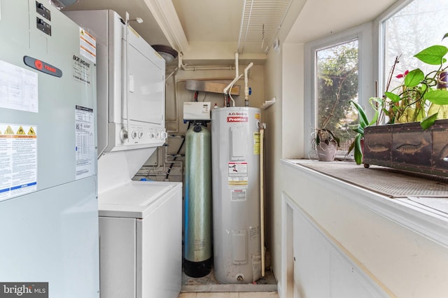 laundry room with electric water heater and stacked washing maching and dryer