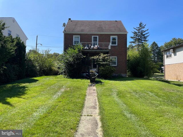 rear view of house featuring a yard