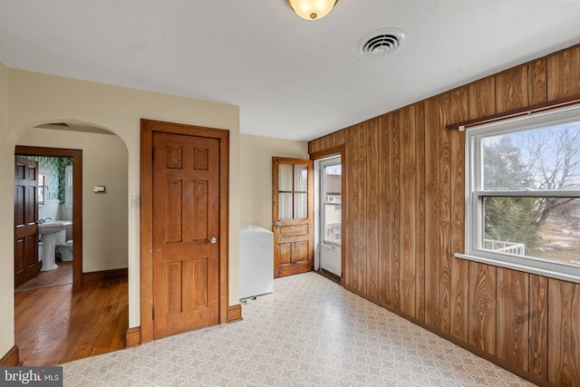 empty room featuring wooden walls