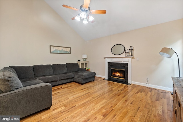 living room with ceiling fan, high vaulted ceiling, and light wood-type flooring