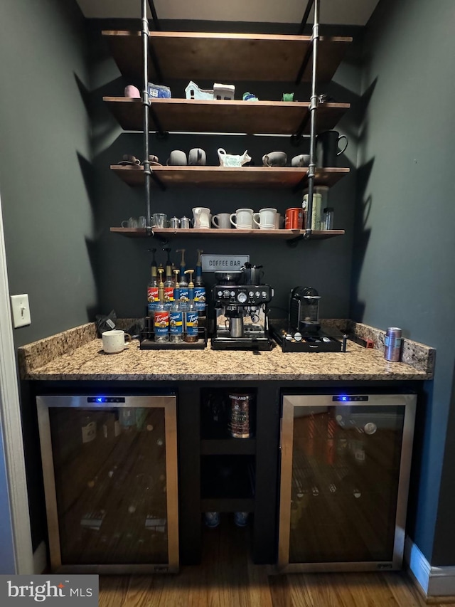 bar featuring hardwood / wood-style floors, light stone countertops, and wine cooler