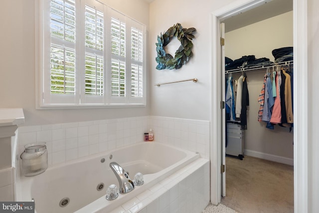 bathroom featuring plenty of natural light and tiled tub