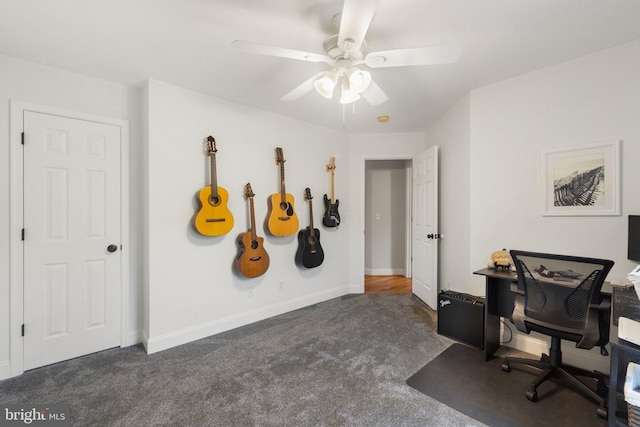 office space with dark carpet and ceiling fan