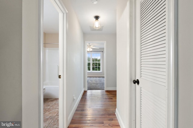 corridor with hardwood / wood-style flooring