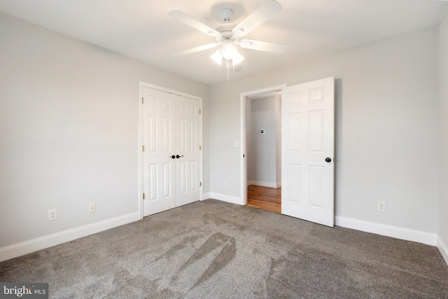 unfurnished bedroom featuring carpet, ceiling fan, and a closet