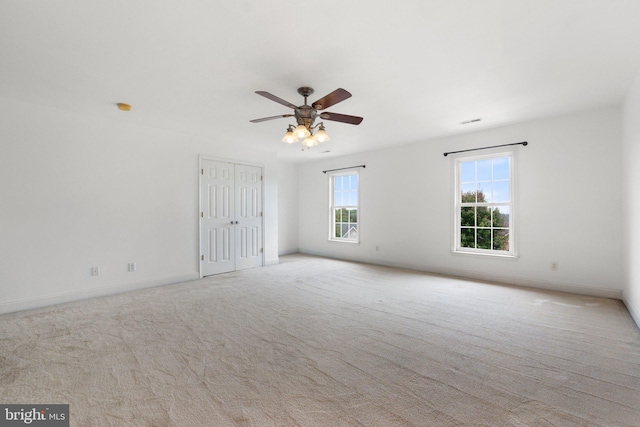 unfurnished room with ceiling fan and light colored carpet