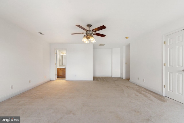 unfurnished room with light colored carpet and ceiling fan