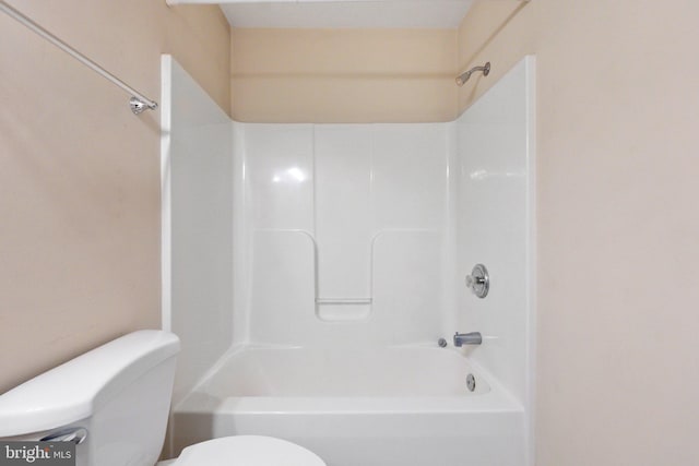 bathroom with bathing tub / shower combination and toilet