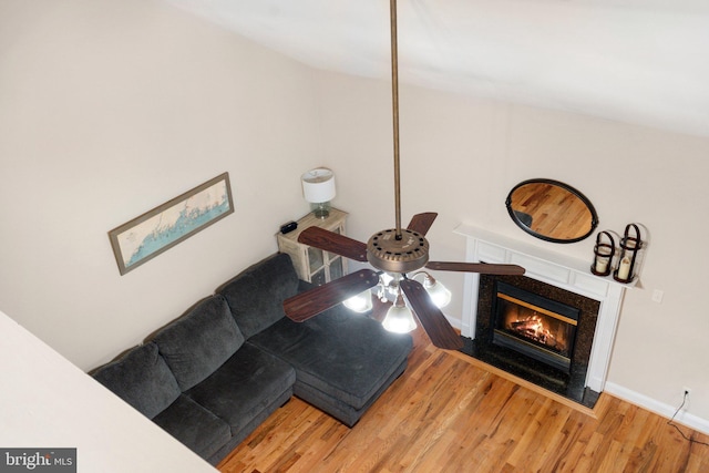 living room featuring wood-type flooring and ceiling fan