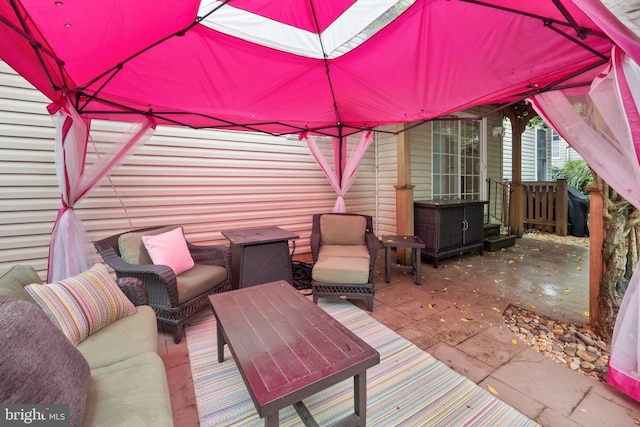 wooden terrace featuring outdoor lounge area and a patio area