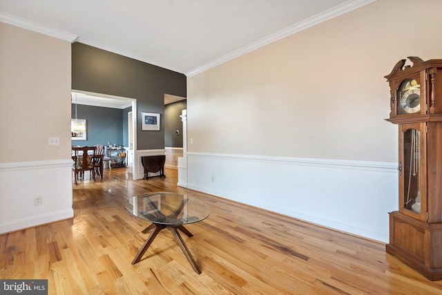 interior space featuring hardwood / wood-style floors, a notable chandelier, and ornamental molding