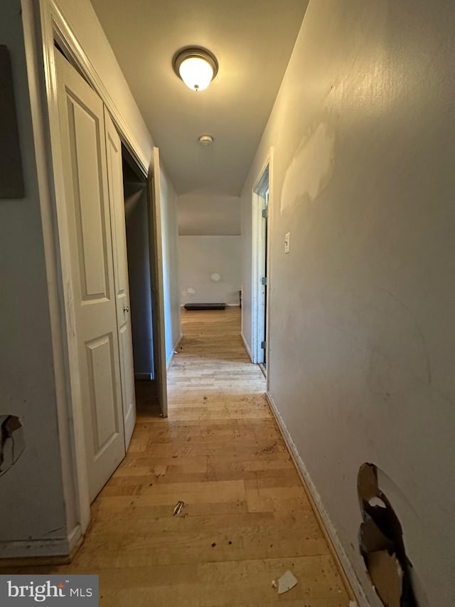 corridor with light hardwood / wood-style flooring