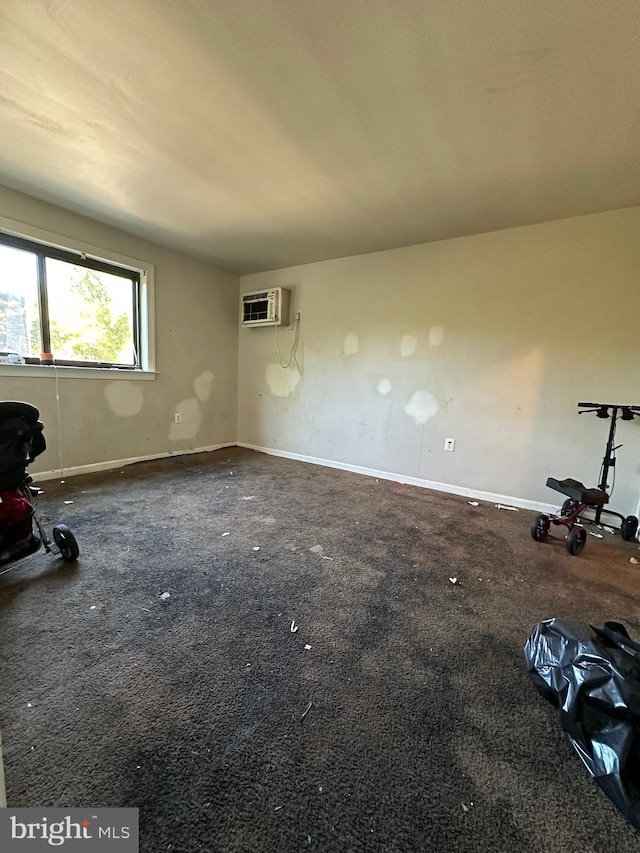 interior space featuring carpet and an AC wall unit