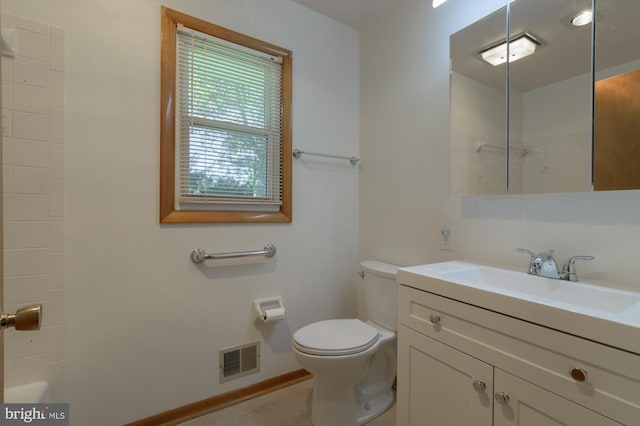 bathroom with vanity, toilet, and walk in shower