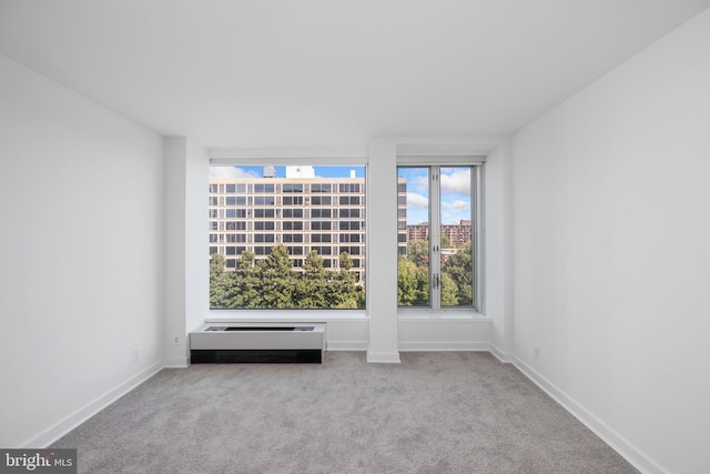 empty room with light carpet and a wall unit AC