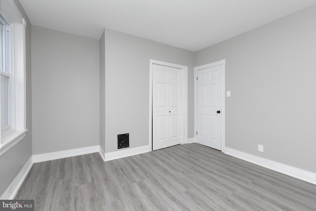 spare room with light hardwood / wood-style floors