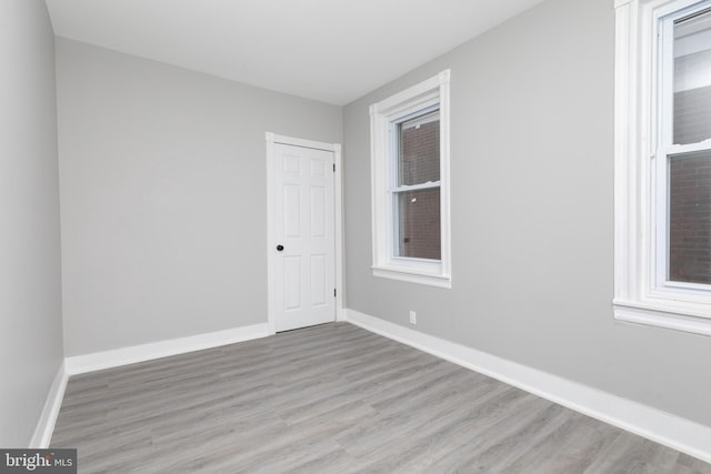 unfurnished room featuring light hardwood / wood-style floors