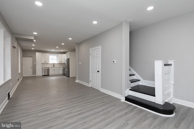 living room with light hardwood / wood-style floors and sink