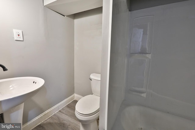 full bathroom featuring shower / washtub combination, toilet, sink, and hardwood / wood-style flooring