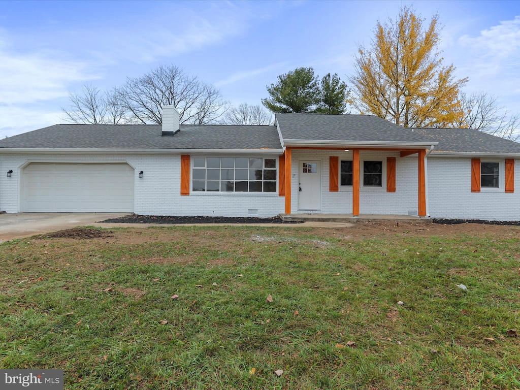 ranch-style house with covered porch, a garage, and a front yard