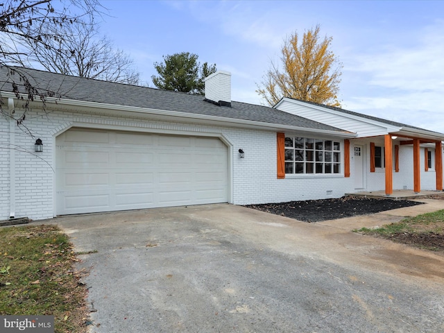 ranch-style house with covered porch and a garage