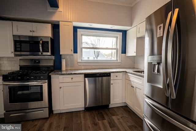 kitchen featuring light stone countertops, appliances with stainless steel finishes, dark wood-type flooring, decorative backsplash, and white cabinetry