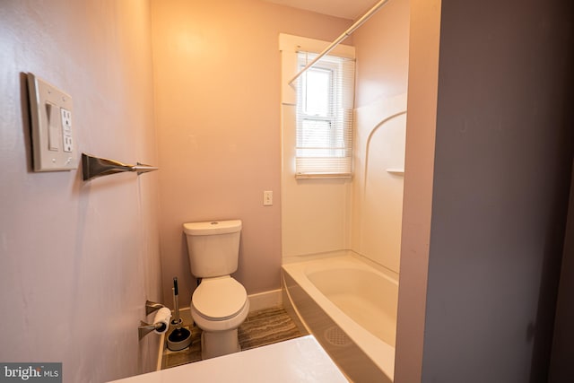 bathroom with toilet and  shower combination