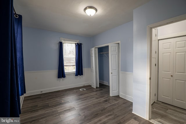 unfurnished bedroom with dark hardwood / wood-style floors