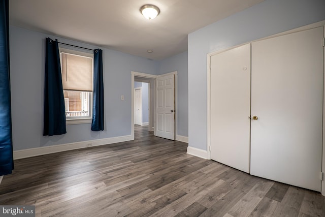 unfurnished bedroom with hardwood / wood-style floors and a closet