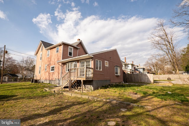 rear view of house featuring a yard