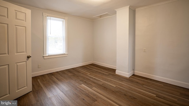 empty room featuring crown molding and dark hardwood / wood-style flooring