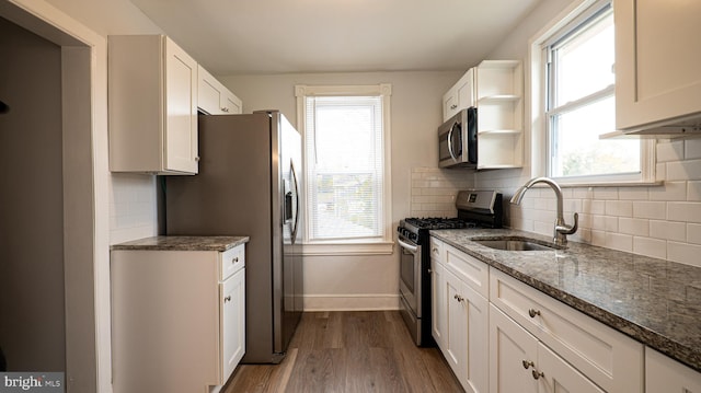 kitchen with plenty of natural light, stainless steel appliances, and sink